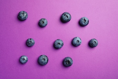 Photo of Flat lay composition with tasty blueberry on color background