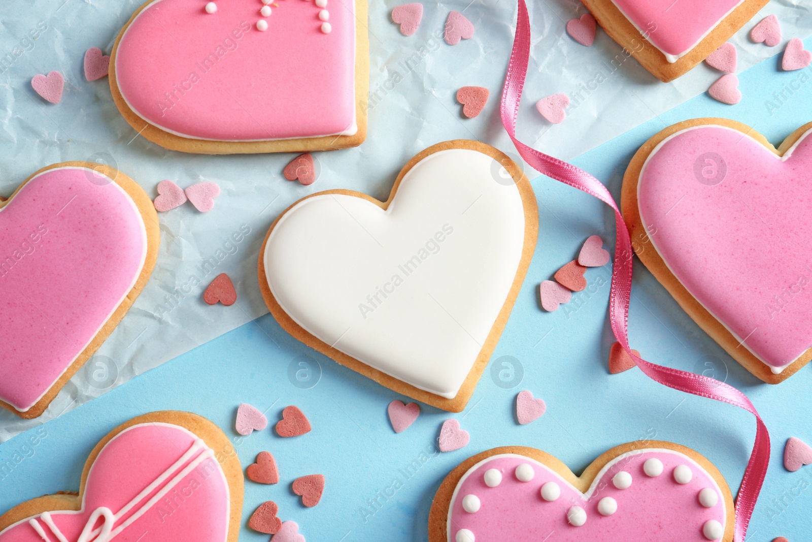 Photo of Decorated heart shaped cookies on color background, flat lay