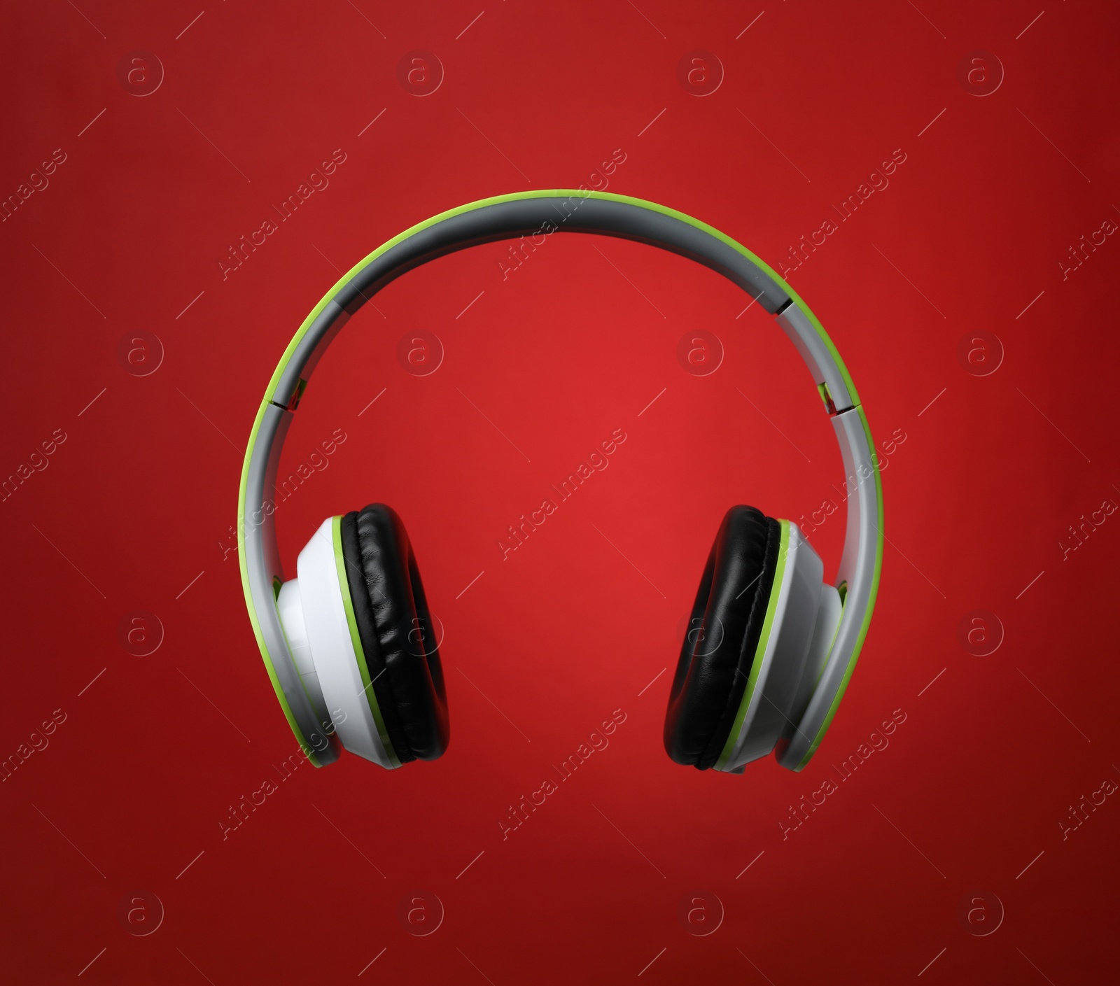 Photo of Stylish modern headphones with earmuffs on color background