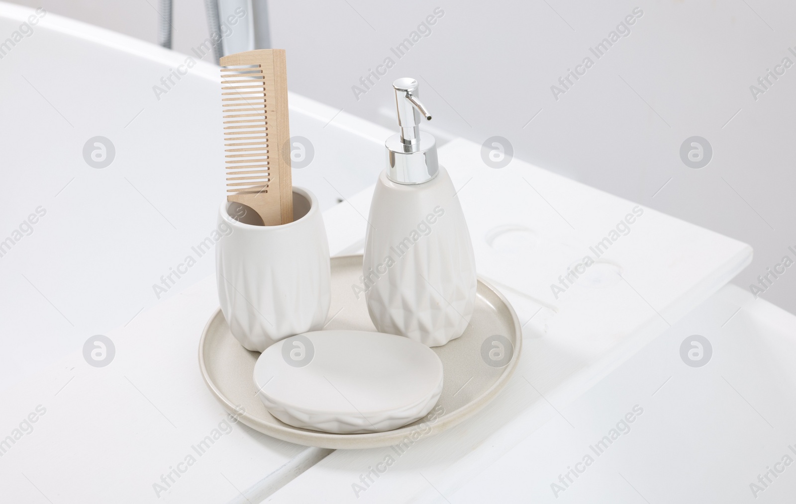 Photo of Different personal care products and accessories on bath tub in bathroom