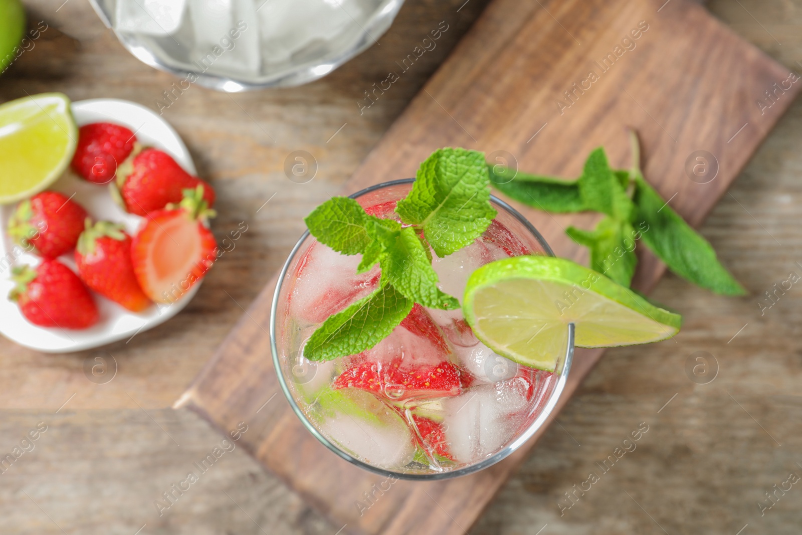 Photo of Flat lay composition with glass of natural lemonade on table