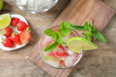 Photo of Flat lay composition with glass of natural lemonade on table