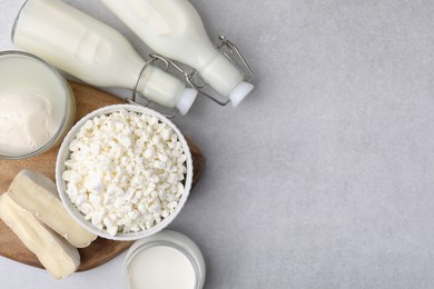 Different fresh dairy products on light table, flat lay. Space for text