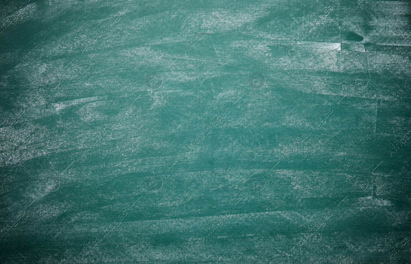 Photo of Dirty green chalkboard as background. Space for text