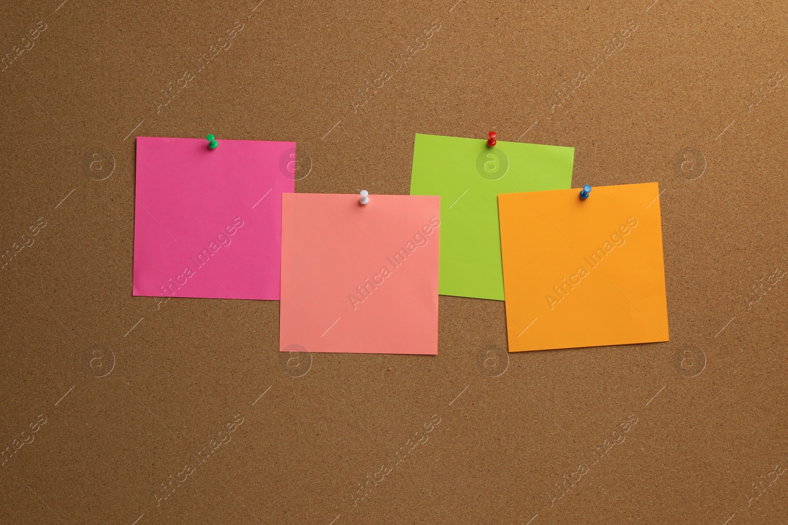 Photo of Colorful paper notes pinned to cork board