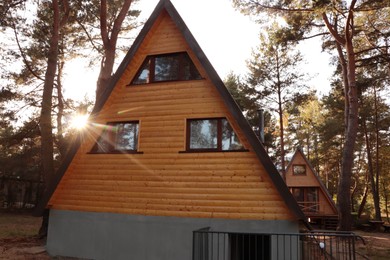 Photo of Picturesque view of modern wooden house near forest on sunny day