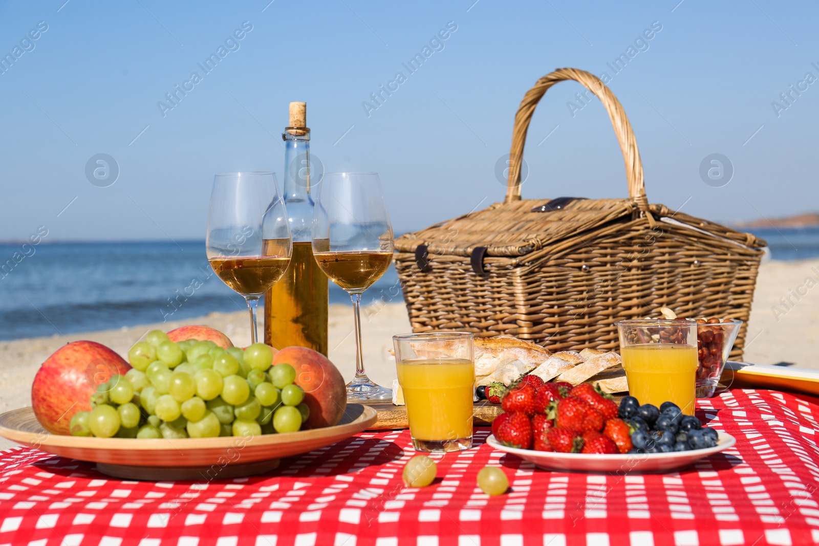 Photo of Food and drinks on beach. Summer picnic