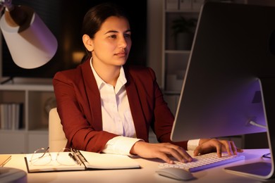 Photo of Tired businesswoman working at table in office