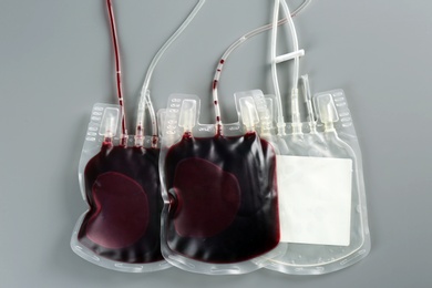 Blood packs on gray background, top view. Donation day