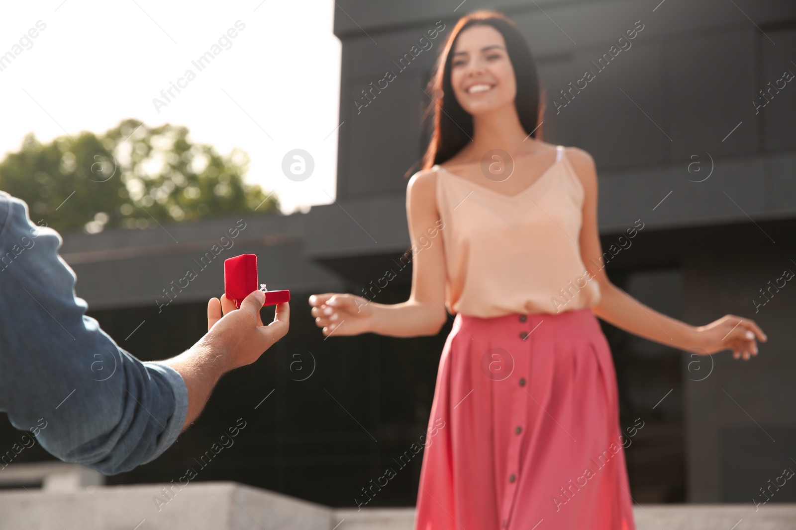 Photo of Man with engagement ring making proposal to his girlfriend outdoors, closeup