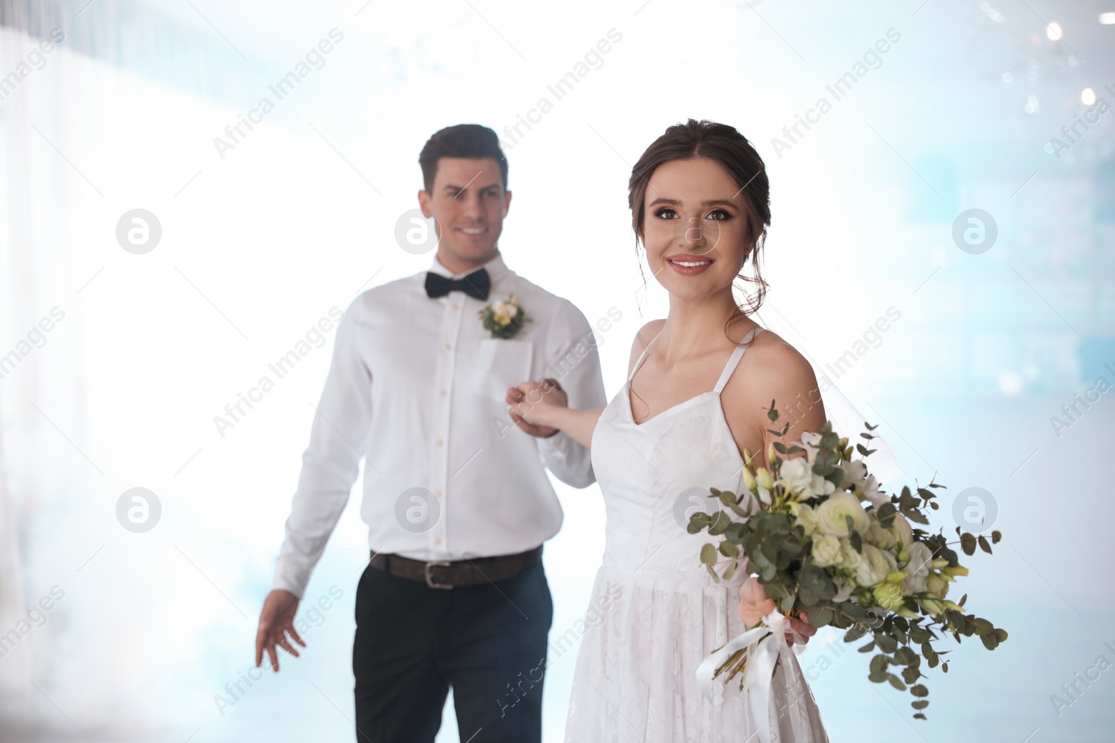 Photo of Happy newlywed couple dancing together in festive hall