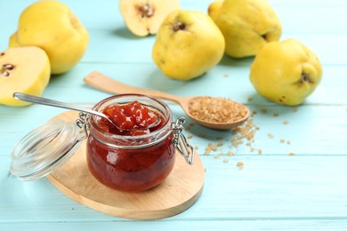 Photo of Delicious quince jam on light blue wooden table, closeup