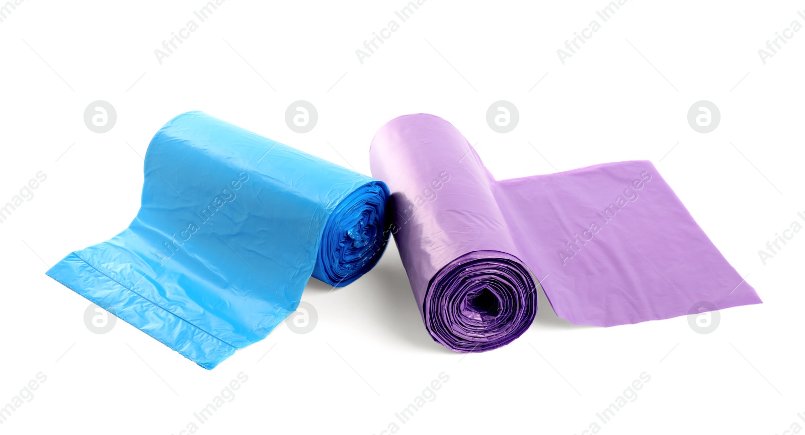 Photo of Rolls of different garbage bags on white background. Cleaning supplies