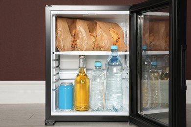 Photo of Mini bar filled with food and drinks indoors, closeup