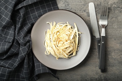 Photo of Fresh white carrot salad served on grey table, flat lay