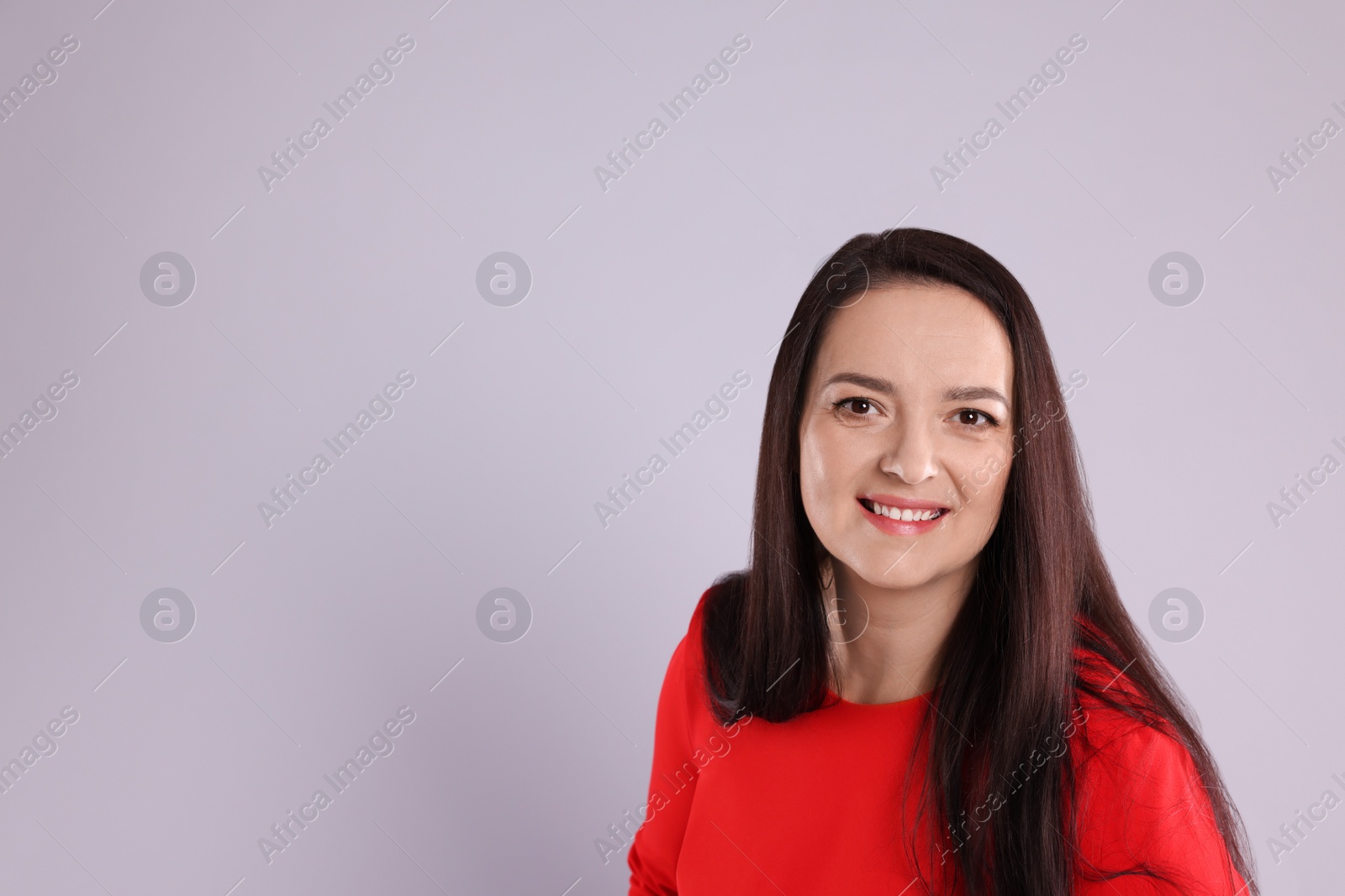 Photo of Beautiful overweight woman in red dress on light grey background. Space for text