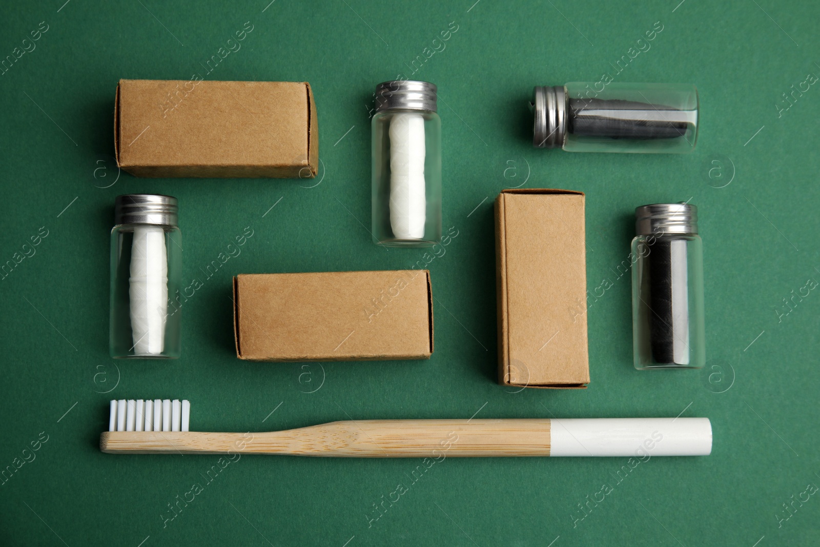 Photo of Flat lay composition with natural dental floss on green background