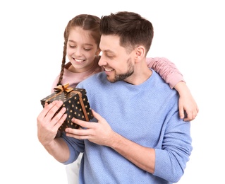 Man receiving gift for Father's Day from his daughter on white background