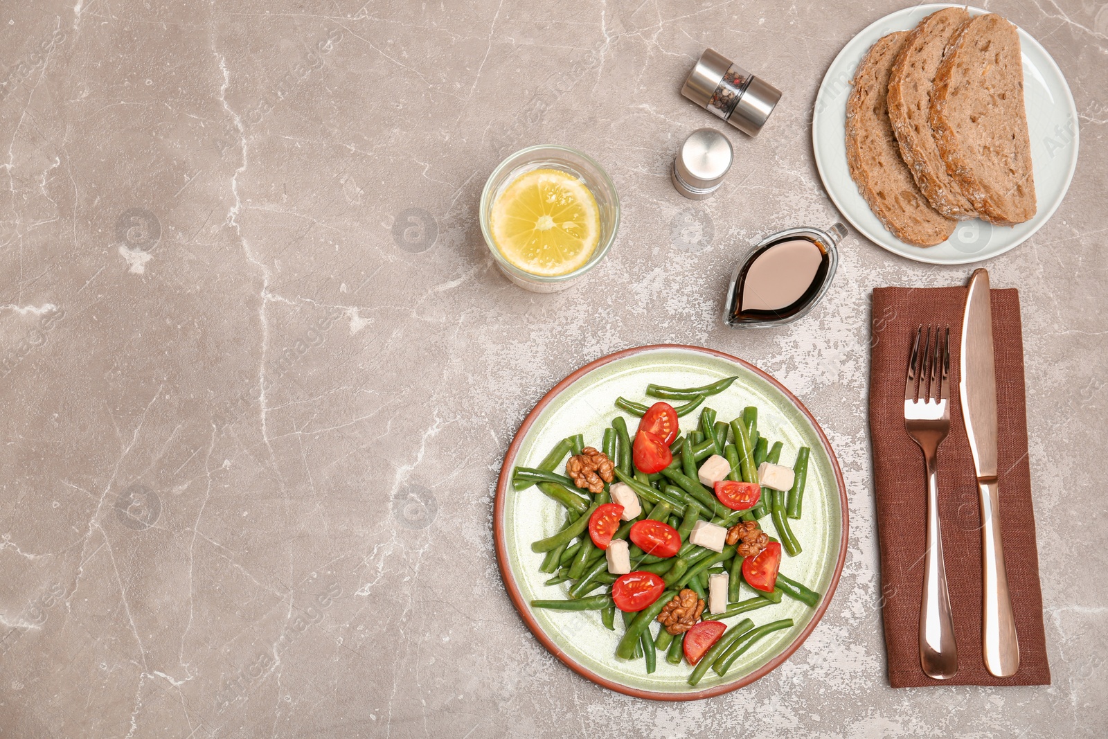 Photo of Flat lay composition with tasty green beans, cheese, nuts and tomatoes on grey background