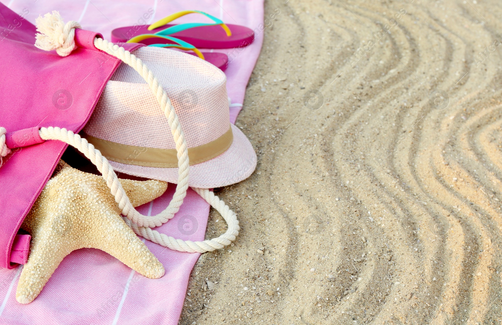 Photo of Composition with beach accessories on sand. Space for text