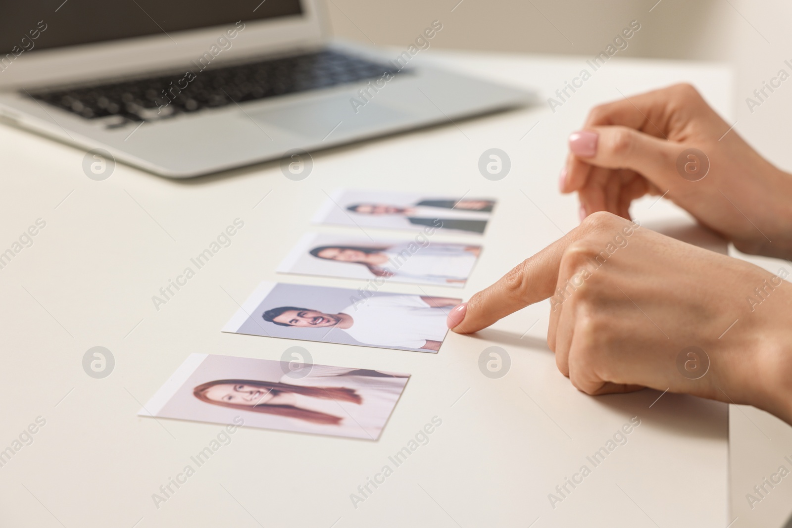 Photo of Human resources manager choosing employee among different applicants at table, closeup