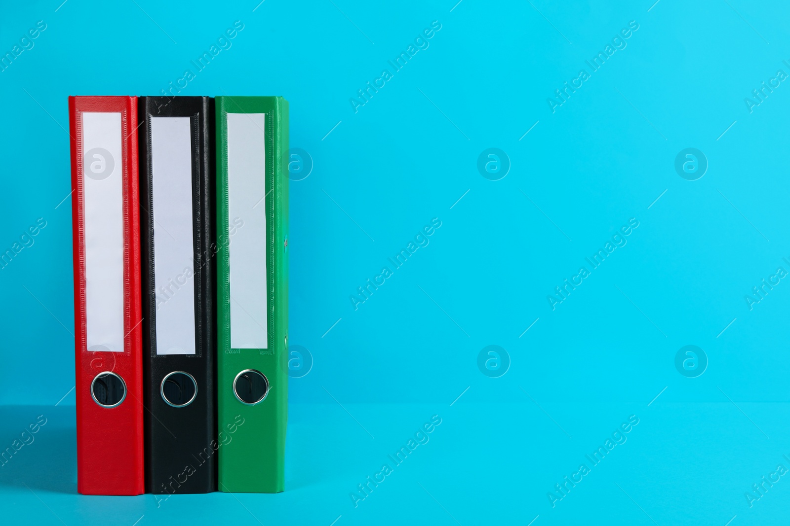 Photo of Office folders on light blue background, space for text