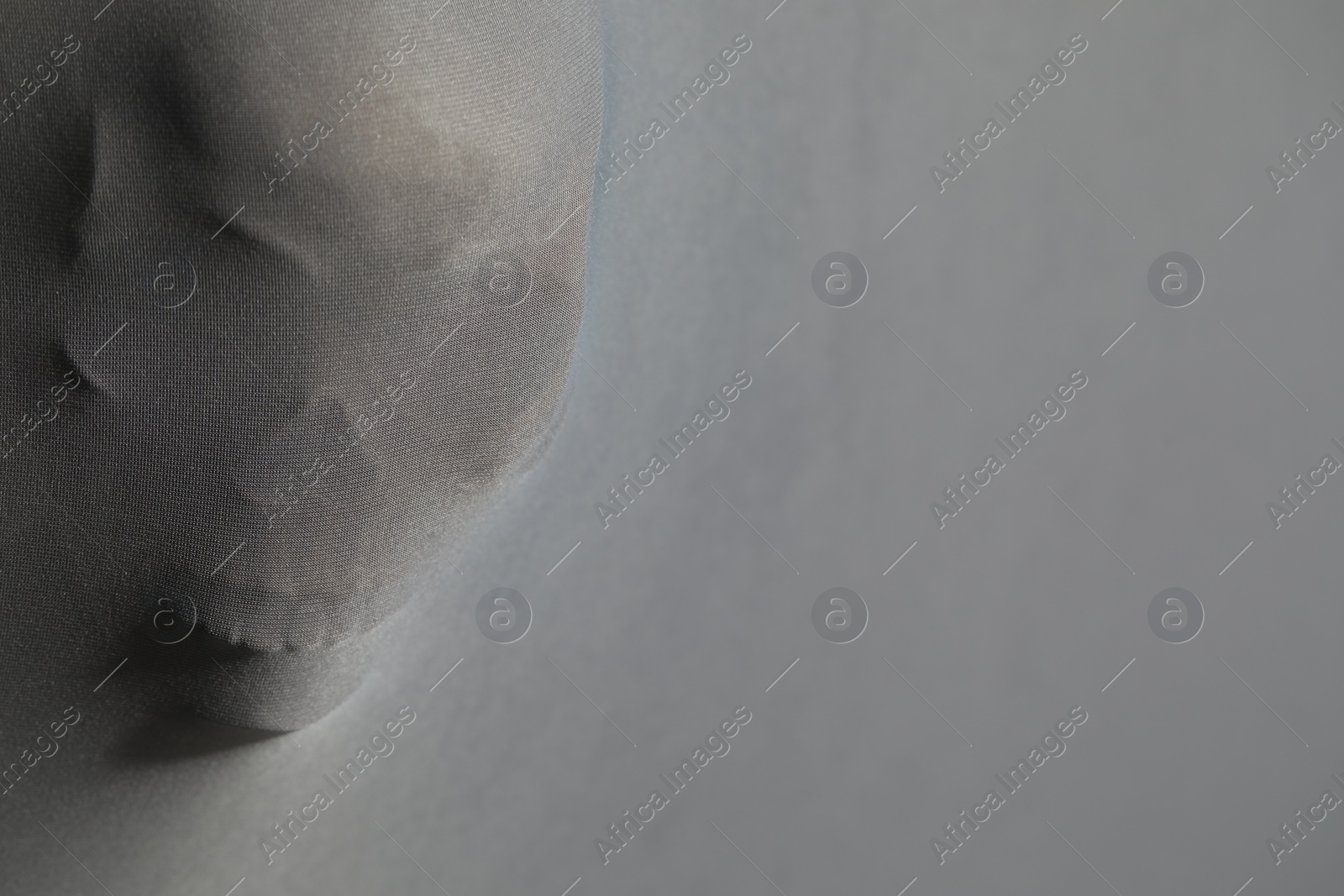 Photo of Silhouette of creepy ghost with skull behind cloth, space for text