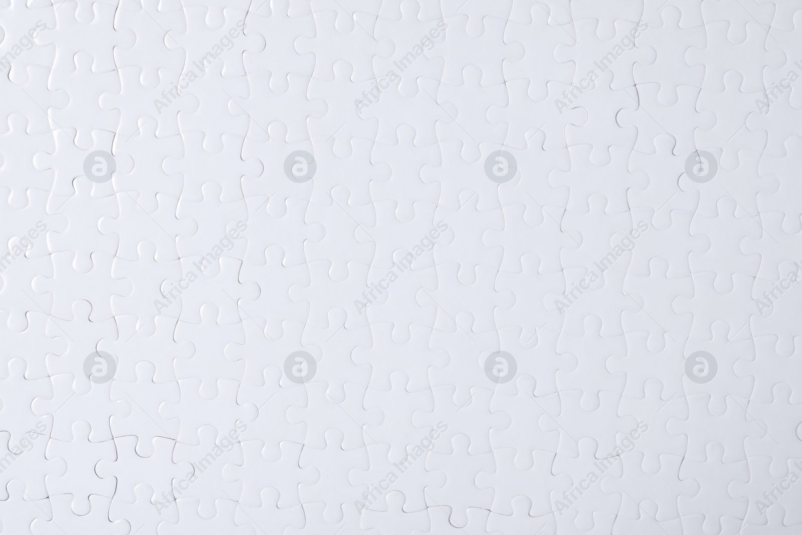 Photo of Blank white puzzle as background, top view