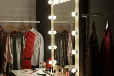 Stylish room with dressing table, mirror and wardrobe rack