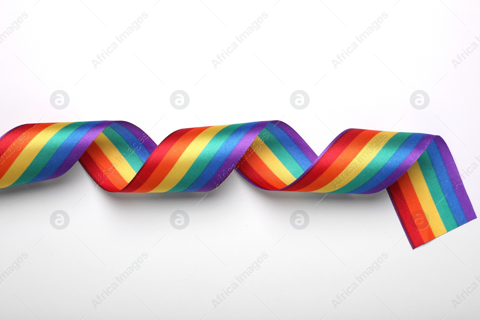 Photo of Rainbow ribbon on white background, top view. LGBT pride