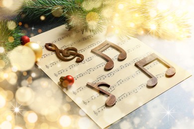 Image of Composition with decoration and music sheet on table. Christmas songs. Bokeh effect