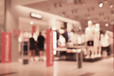 Photo of Blurred view of modern shopping mall interior