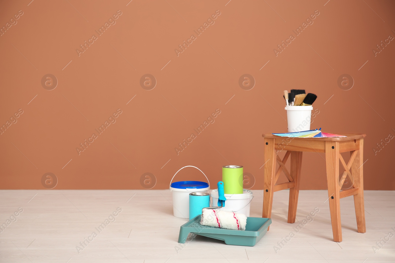 Photo of Decorator's tools near color wall