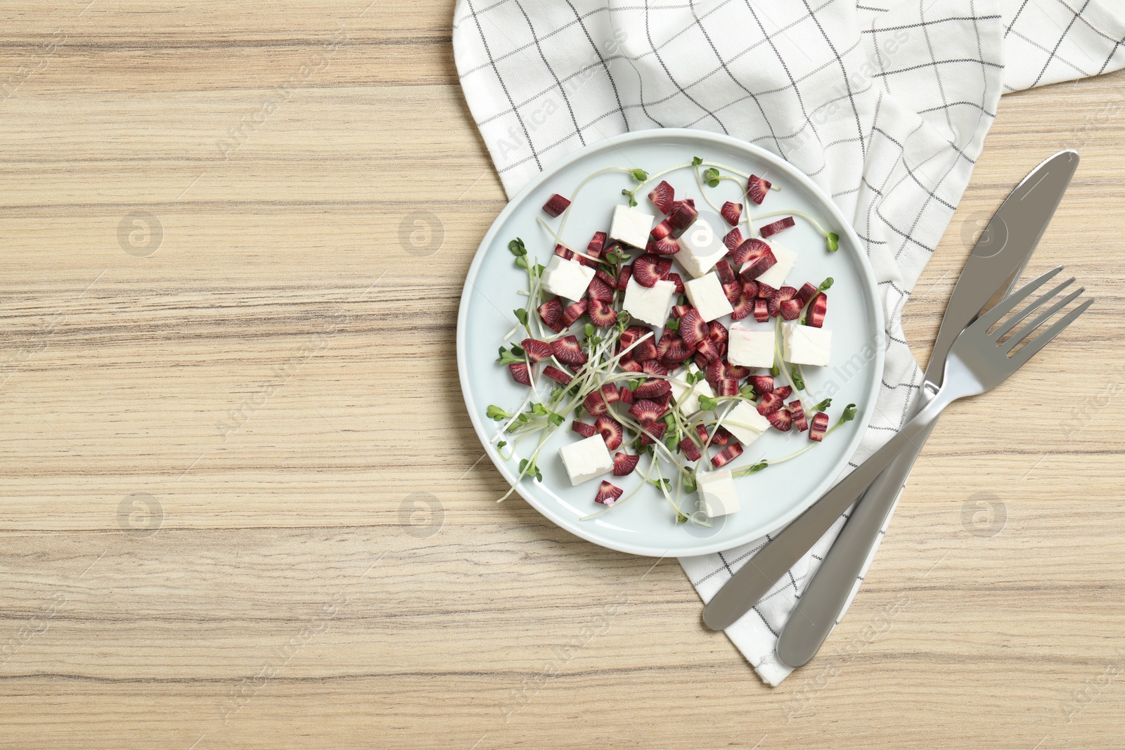 Photo of Delicious fresh carrot salad served on wooden table, flat lay. Space for text