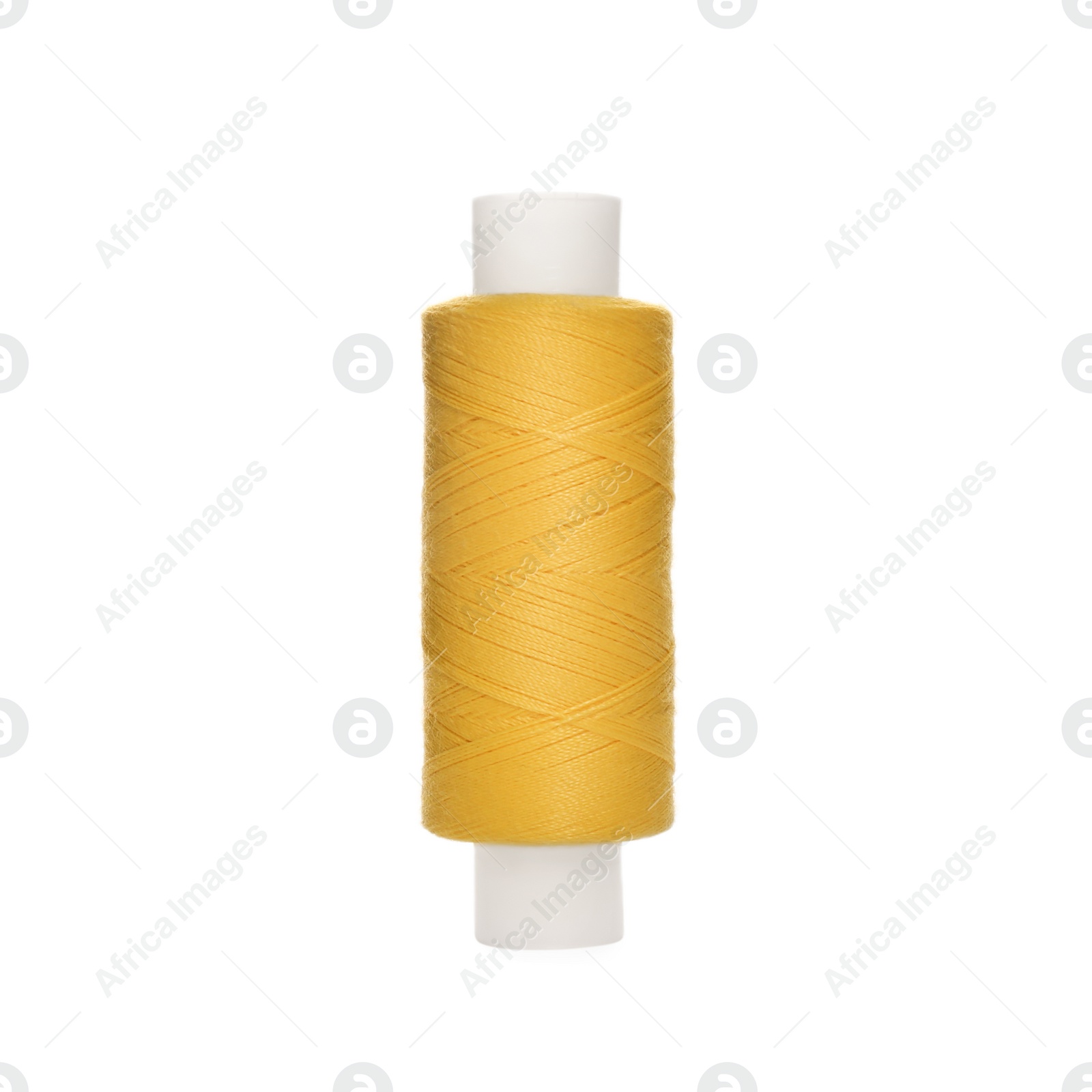 Photo of Spool of yellow sewing thread isolated on white