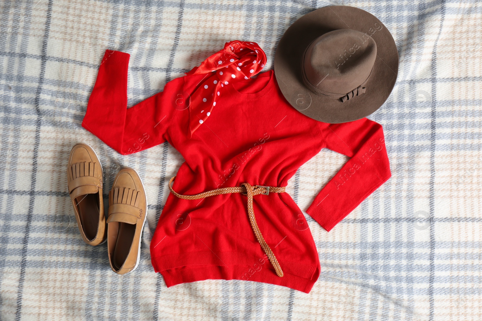 Photo of Flat lay composition with cashmere sweater and hat on soft plaid