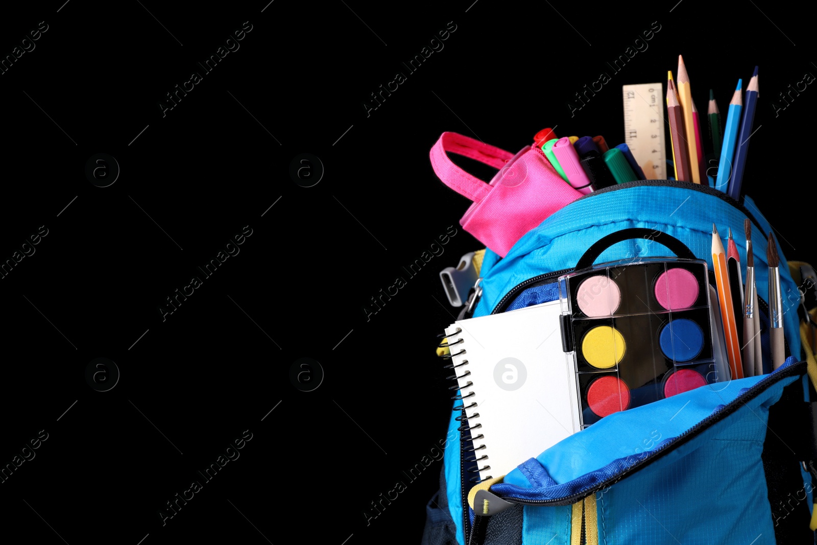 Photo of Backpack with different school stationery near blackboard, space for text