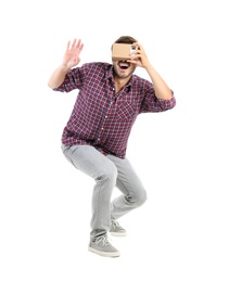 Photo of Young man using cardboard virtual reality headset, isolated on white