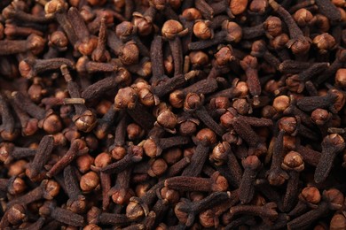 Many aromatic cloves as background, top view