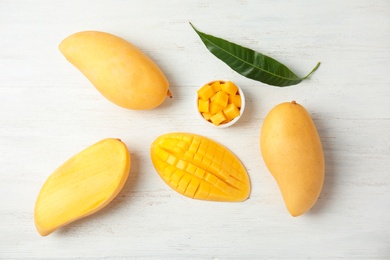 Photo of Flat lay composition with mango on wooden background