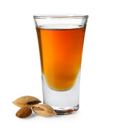 Photo of Shot glass with tasty amaretto liqueur and almonds isolated on white