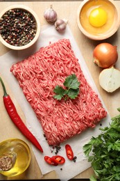 Photo of Raw ground meat and different products on table, flat lay