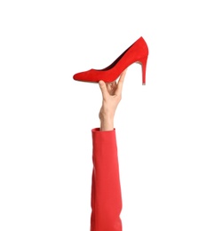 Photo of Woman holding classic high heeled shoe on white background, closeup