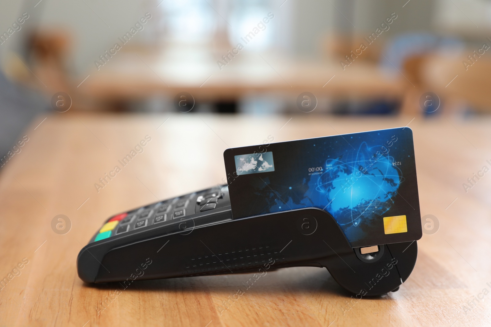 Photo of Credit card machine for non cash payment on wooden table indoors