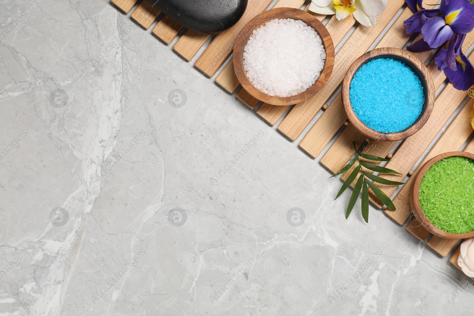 Photo of Flat lay composition with natural sea salt on grey marble table. Space for text