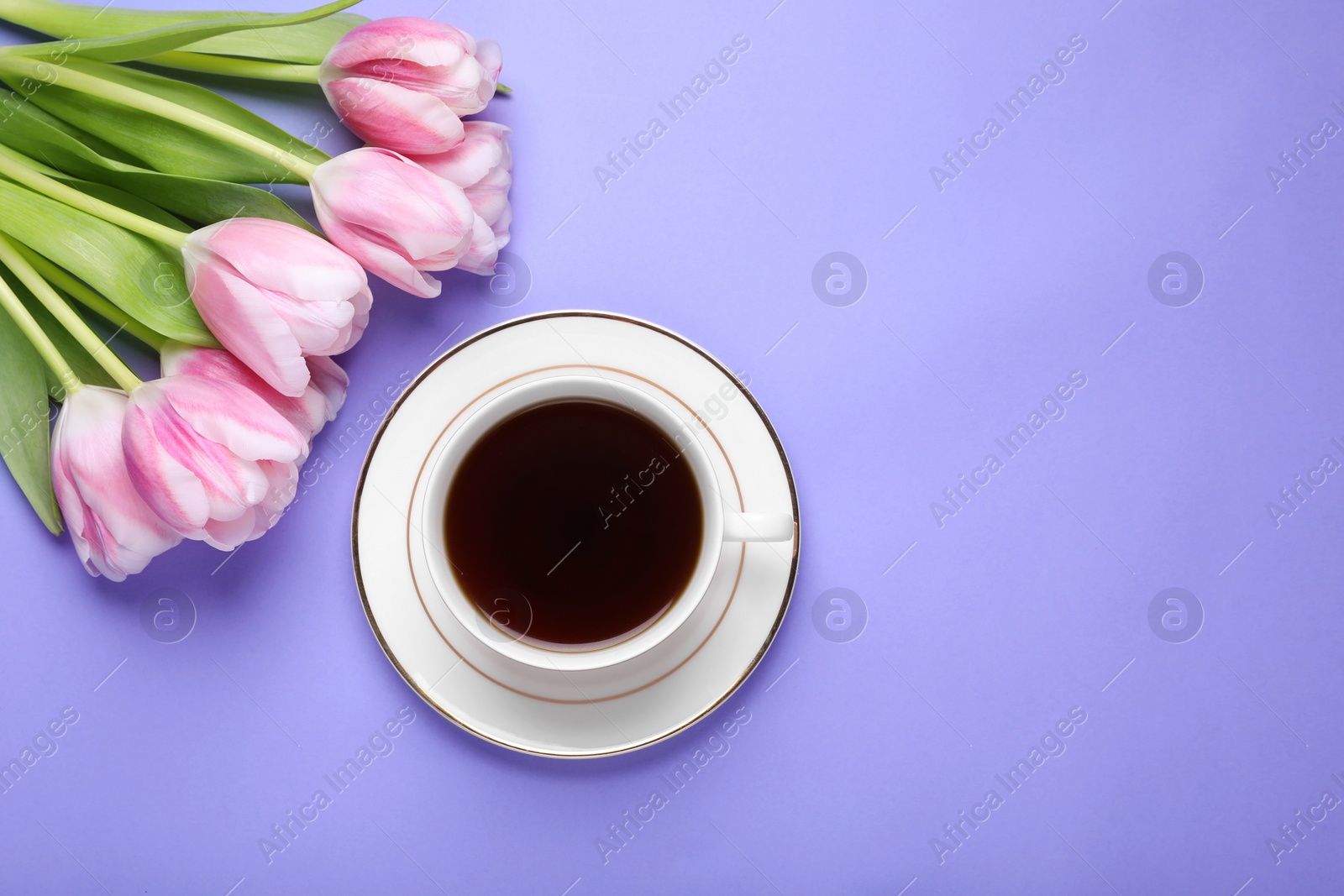 Photo of Cup of coffee and beautiful tulips on light purple background, flat lay. Space for text