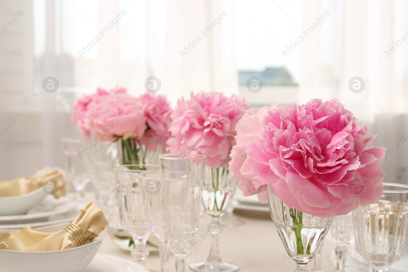 Photo of Stylish table setting with beautiful peonies indoors. Space for text