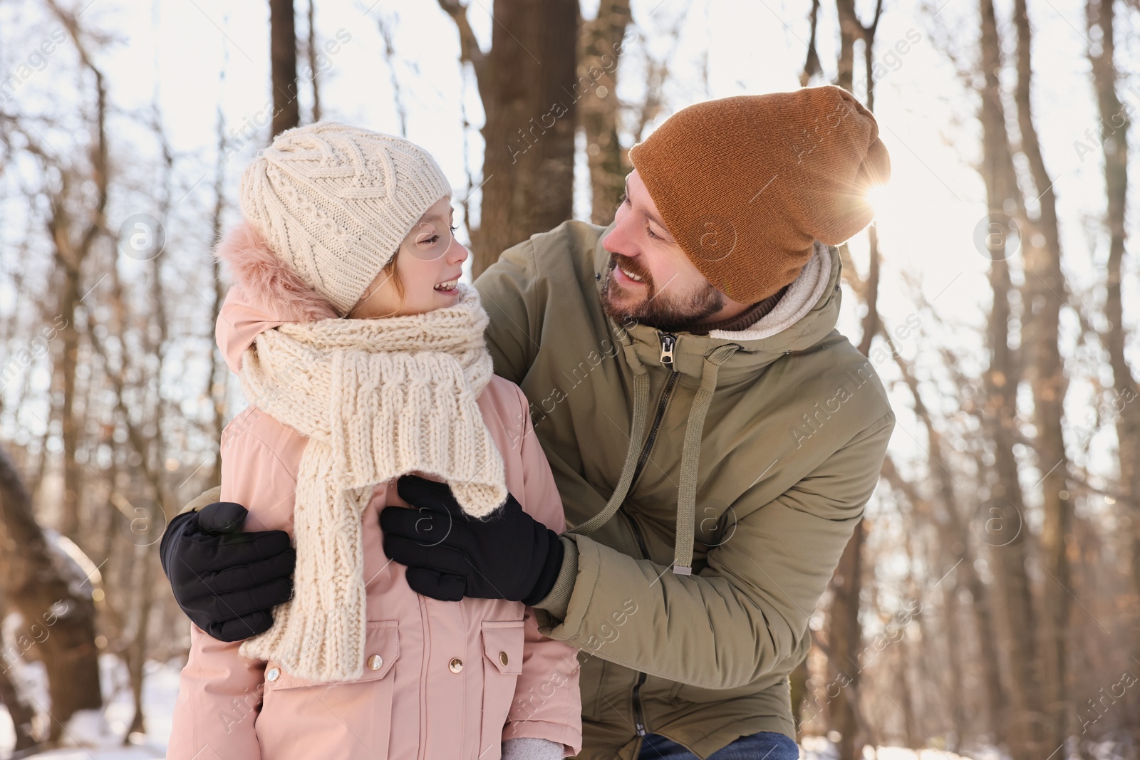 Photo of Family time. Happy father and his daughter in snowy forest