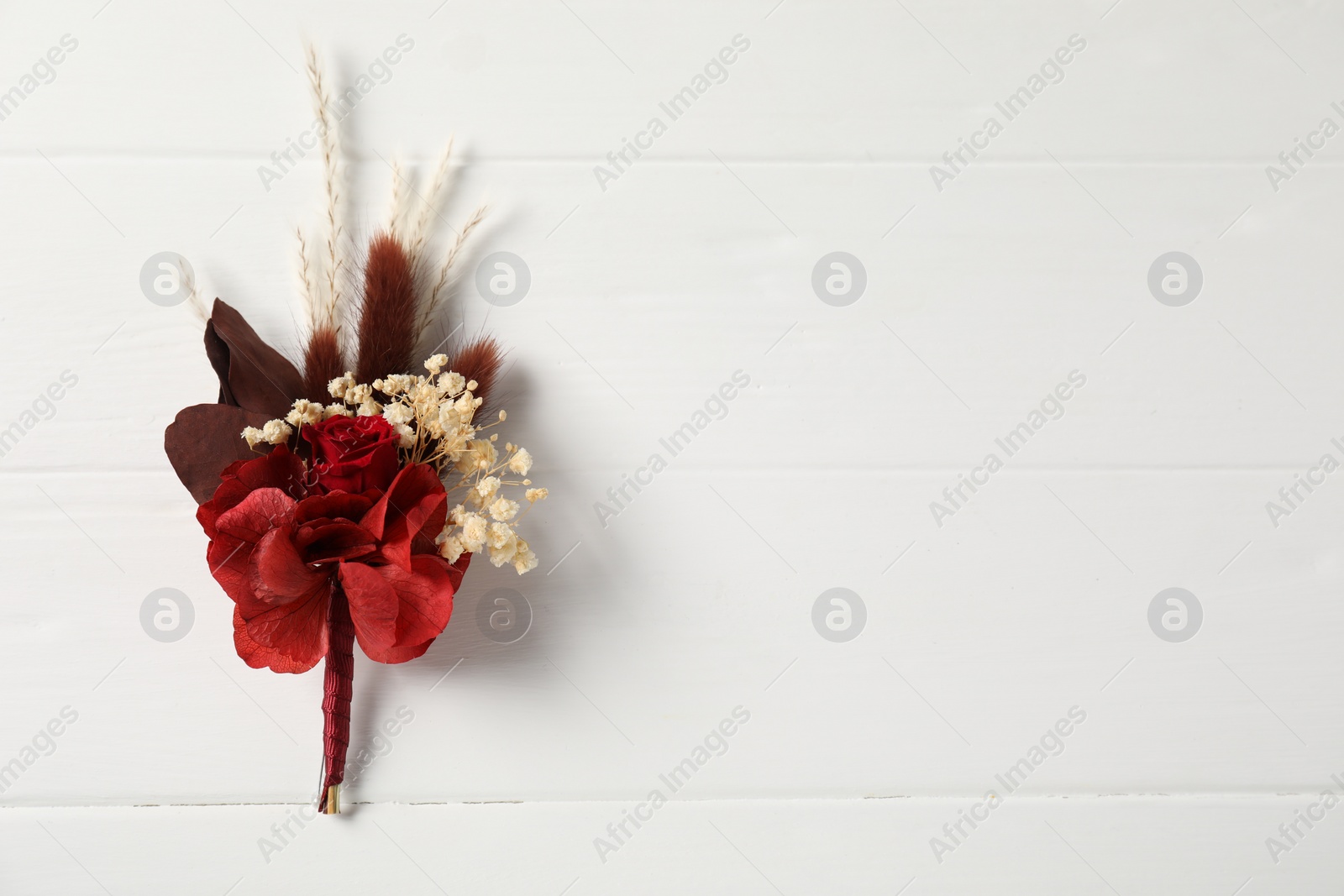 Photo of Beautiful boutonniere on white background, top view. Space for text