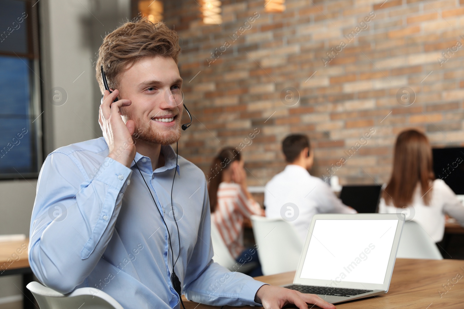 Photo of Technical support operator with headset in modern office